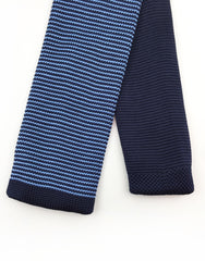 tip of blue pinstriped knitted tie