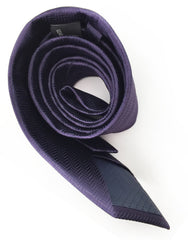 rolled up dark purple necktie